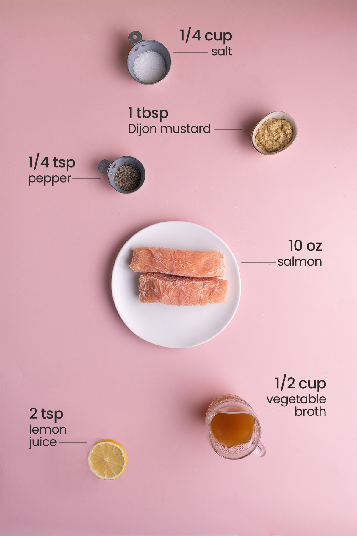 ingredients to cook salmon from frozen: salt, Dijon mustard, pepper, salmon, vegetable broth, lemon juice