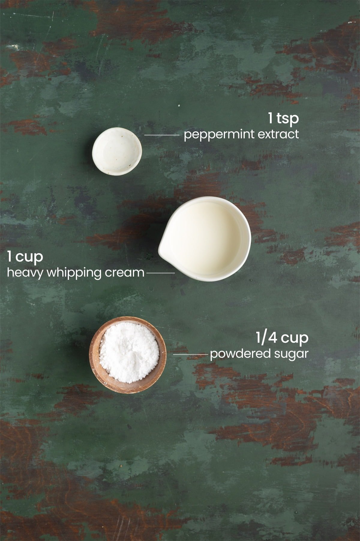 ingredients for peppermint whipped cream - peppermint extract, heavy whipping cream, powdered sugar