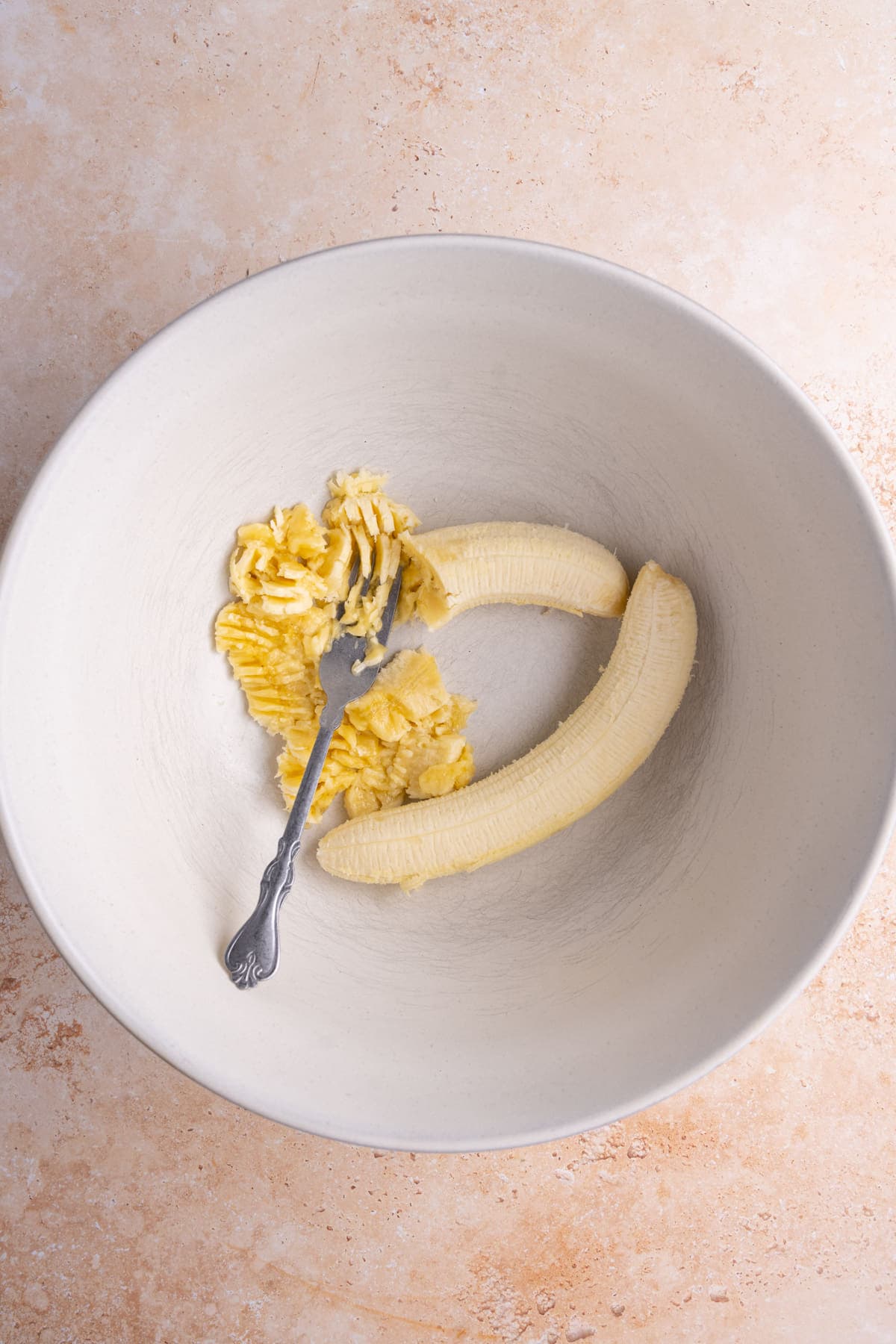 Smashing overripe bananas with a fork