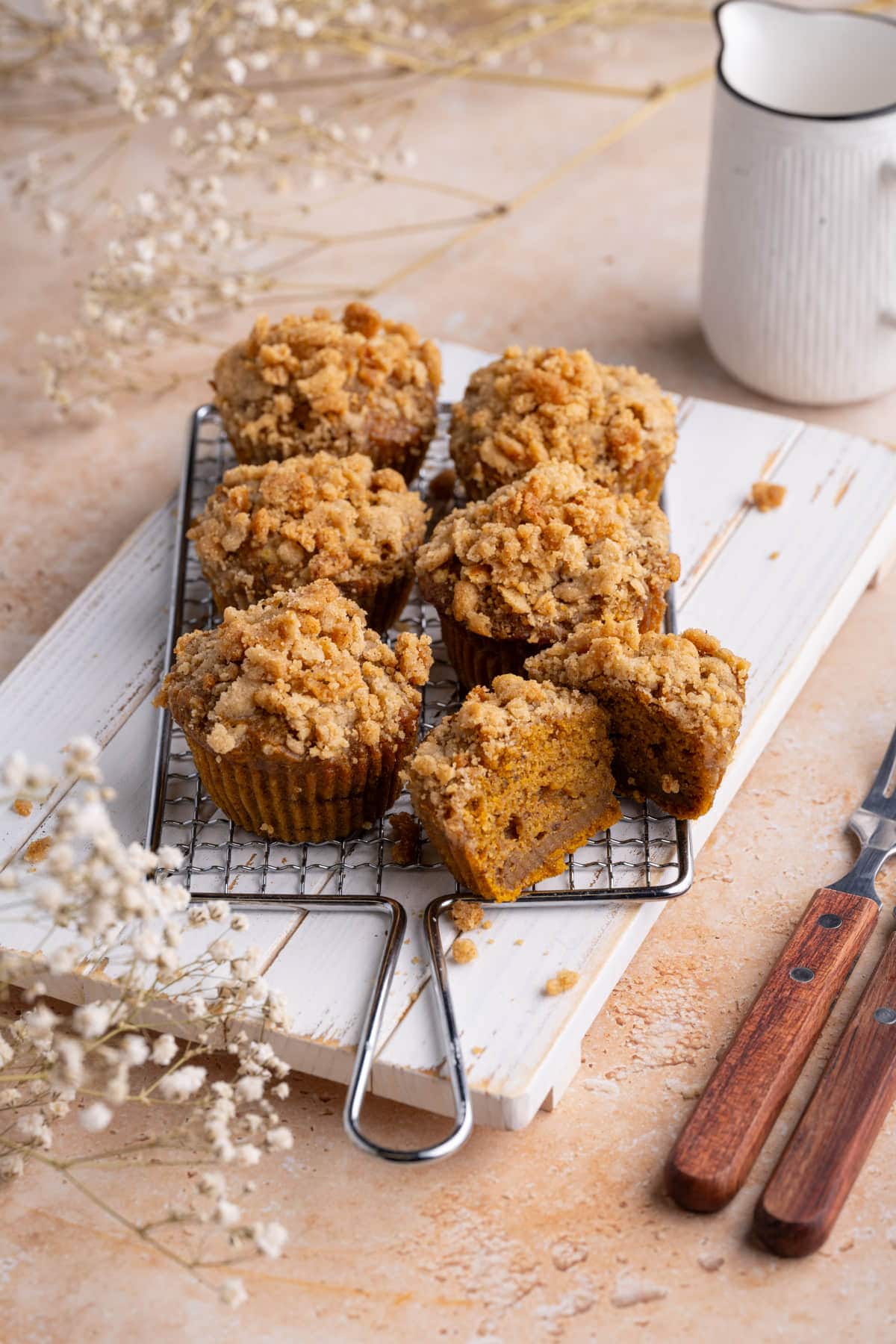 Banana Pumpkin Muffins on cooling rack with one sliced open