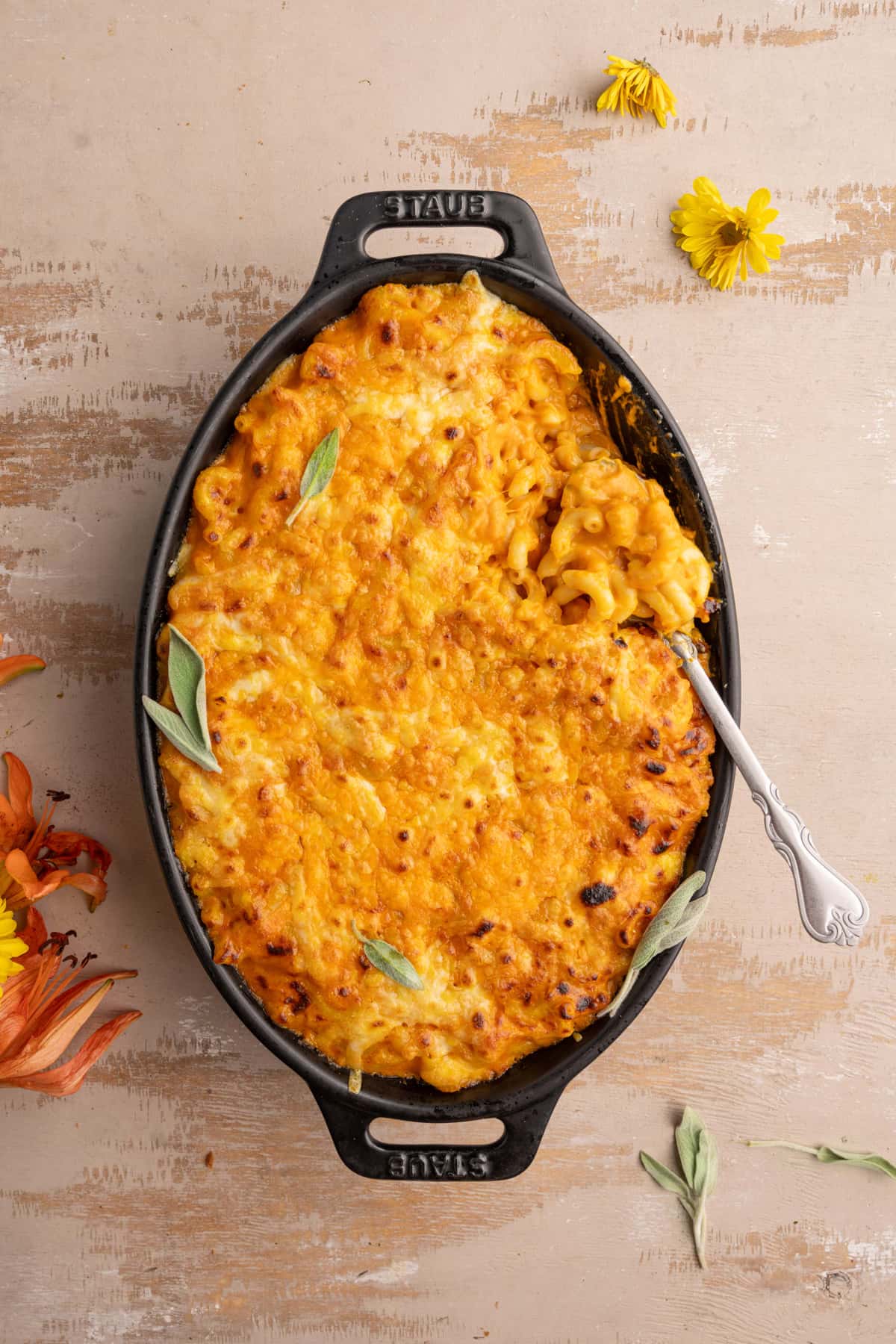 Baked mac and cheese with a serving spoon in it