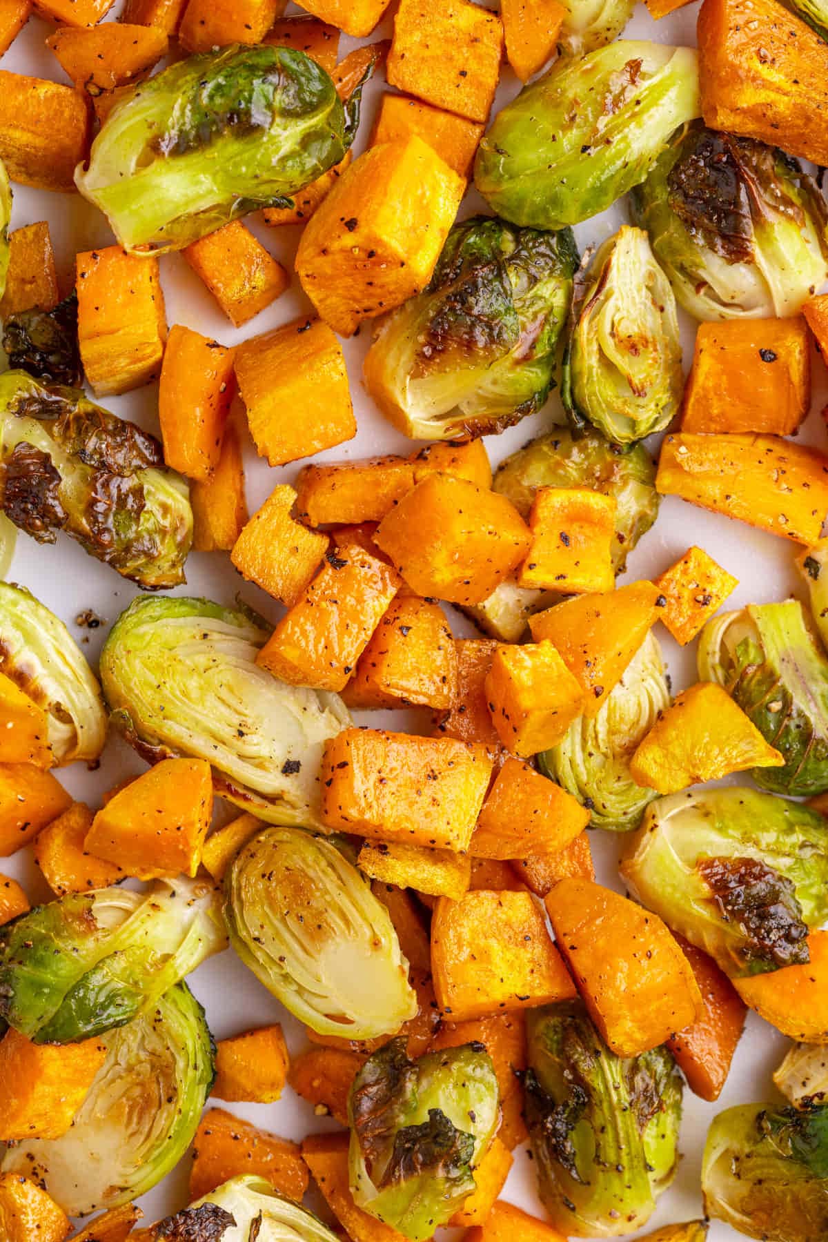 Close up of roasted sweet potatoes and brussels sprouts