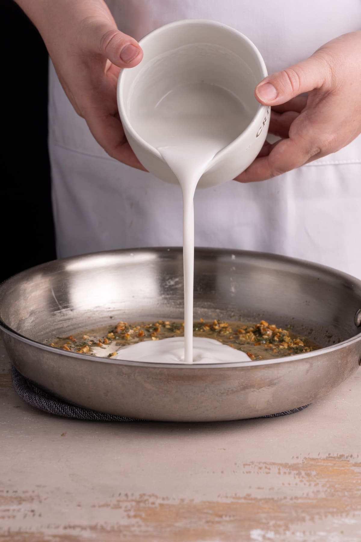 Adding coconut milk to sauteed garlic and sage