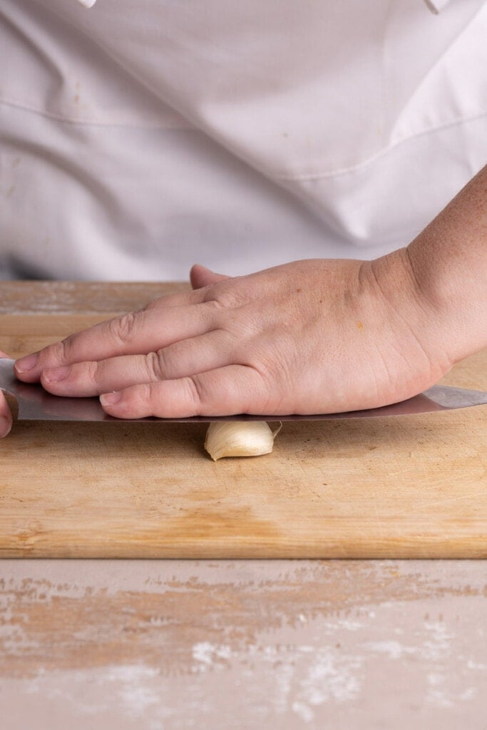 Crushing garlic to more easily peel it