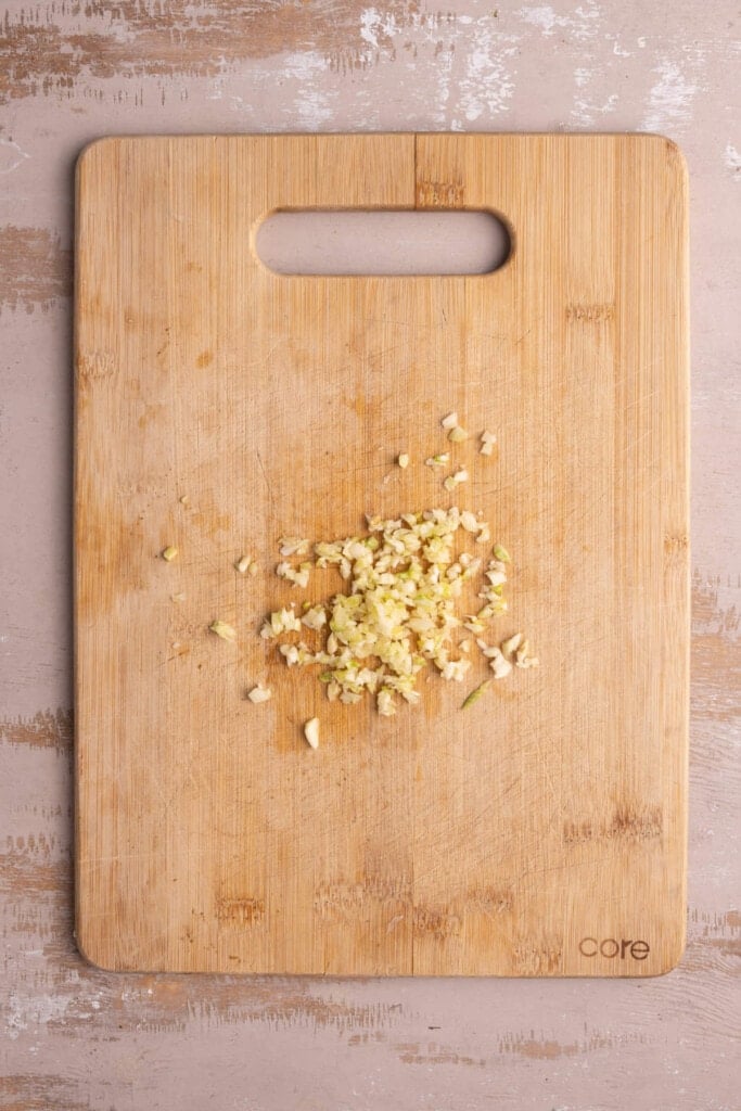 Minced garlic on a chopping board.