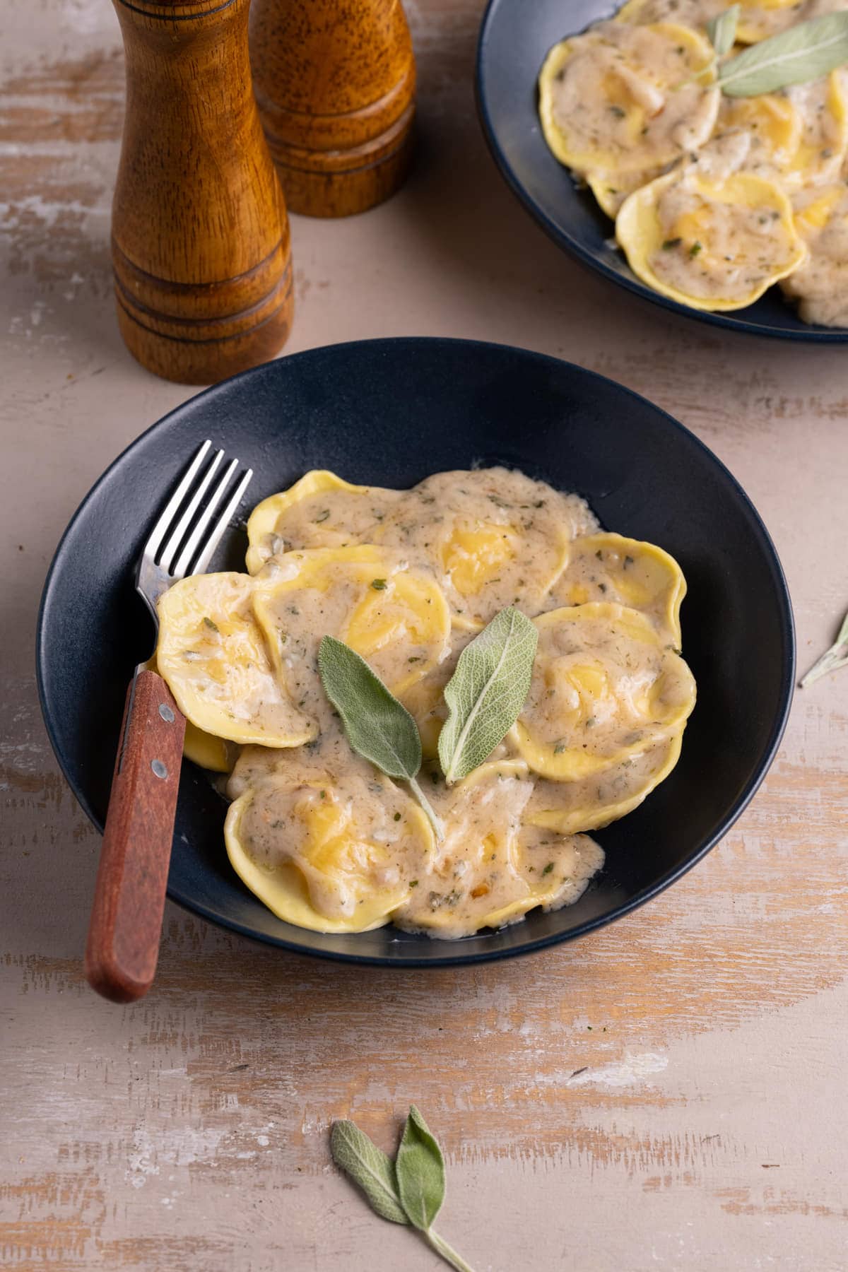 Bowl of butternut squash ravioli with sage cream sauce