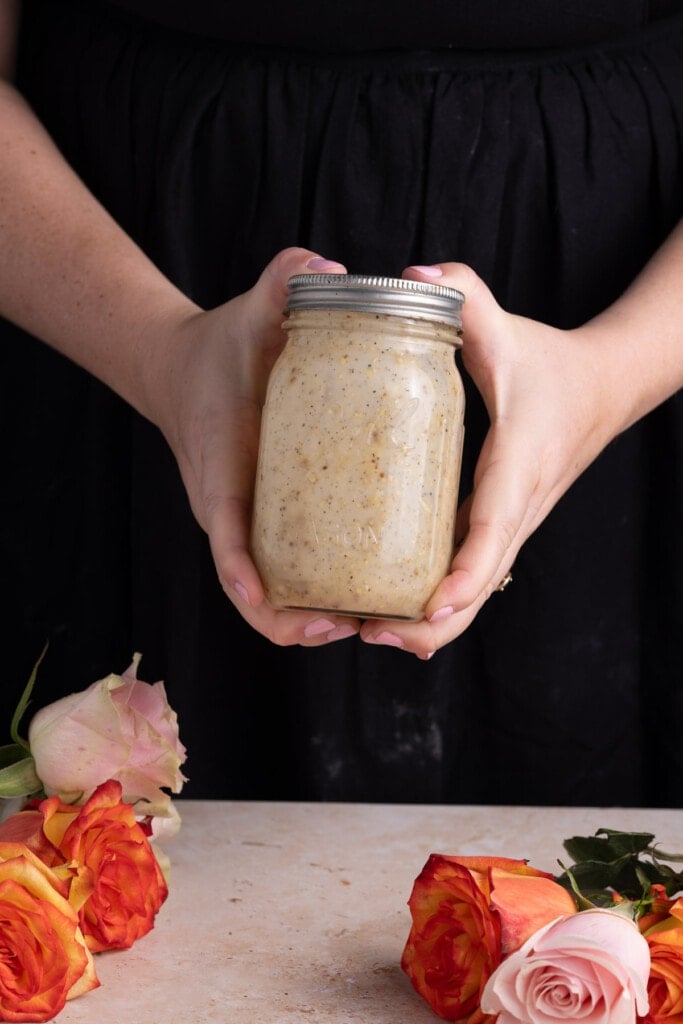 Shaking Caesar dressing in a jar to emulsify