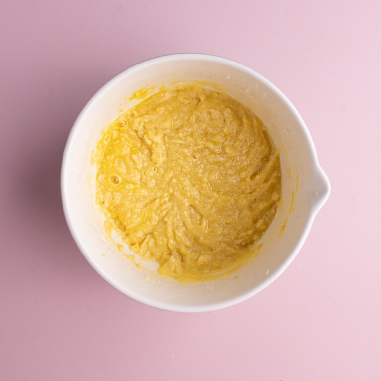 Butter, sugar, eggs, and vanilla extract mixed together in a bowl.