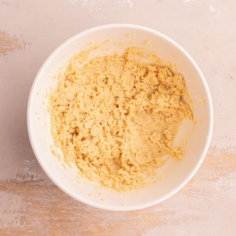 Unsalted butter and light brown sugar creamed together in a bowl.