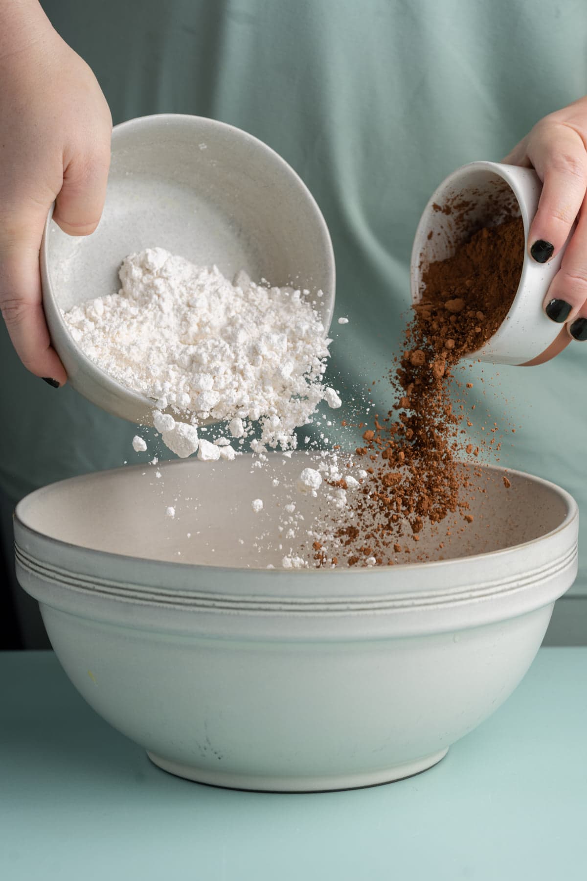 Adding flour and cocoa powder to cookie dough