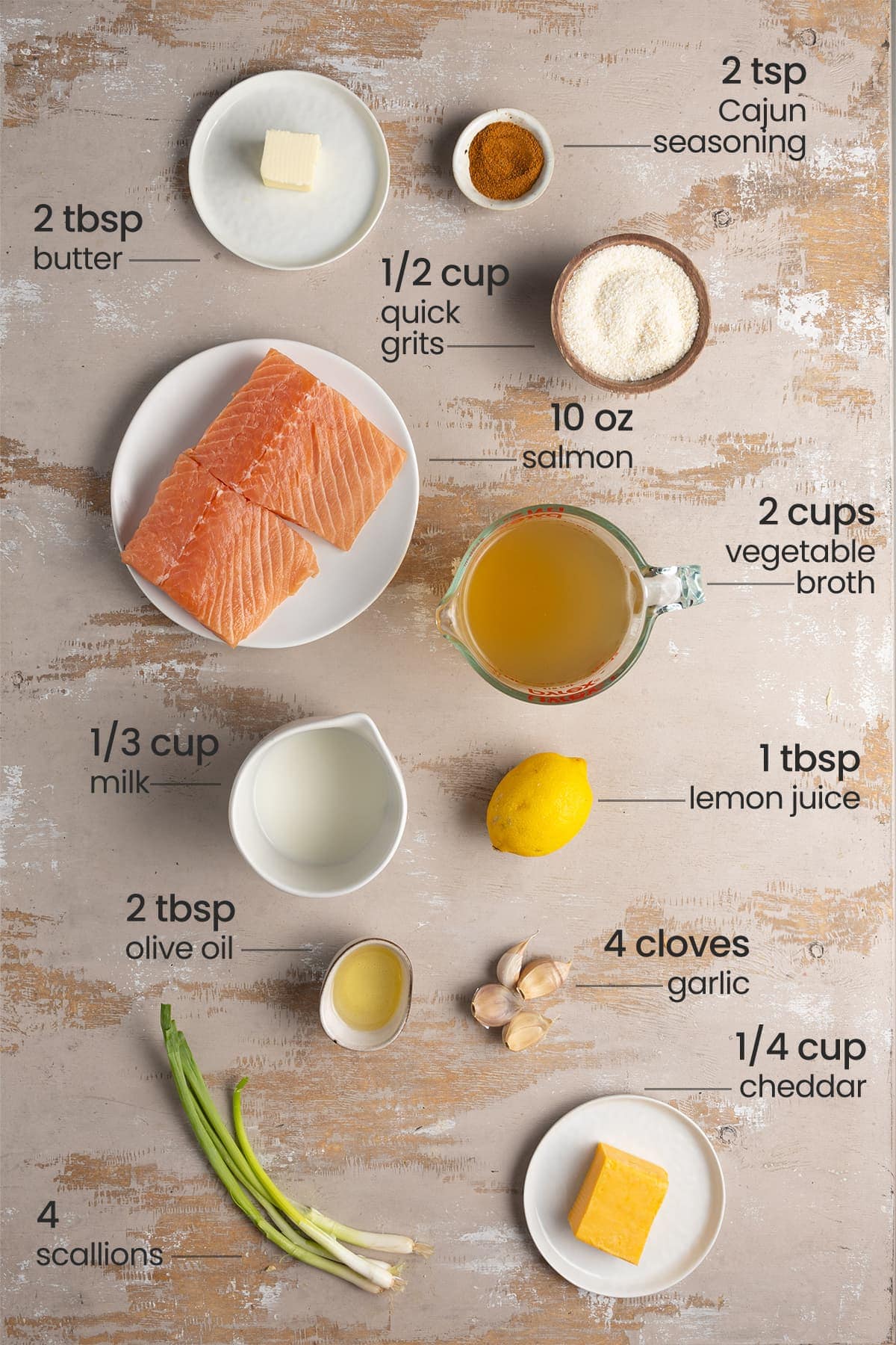 Ingredients for Creamy Cajun Salmon and Grits - butter, quick grits, Cajun seasoning, salmon, milk, vegetable broth, lemon juice, olive oil, garlic, cheddar, scallions