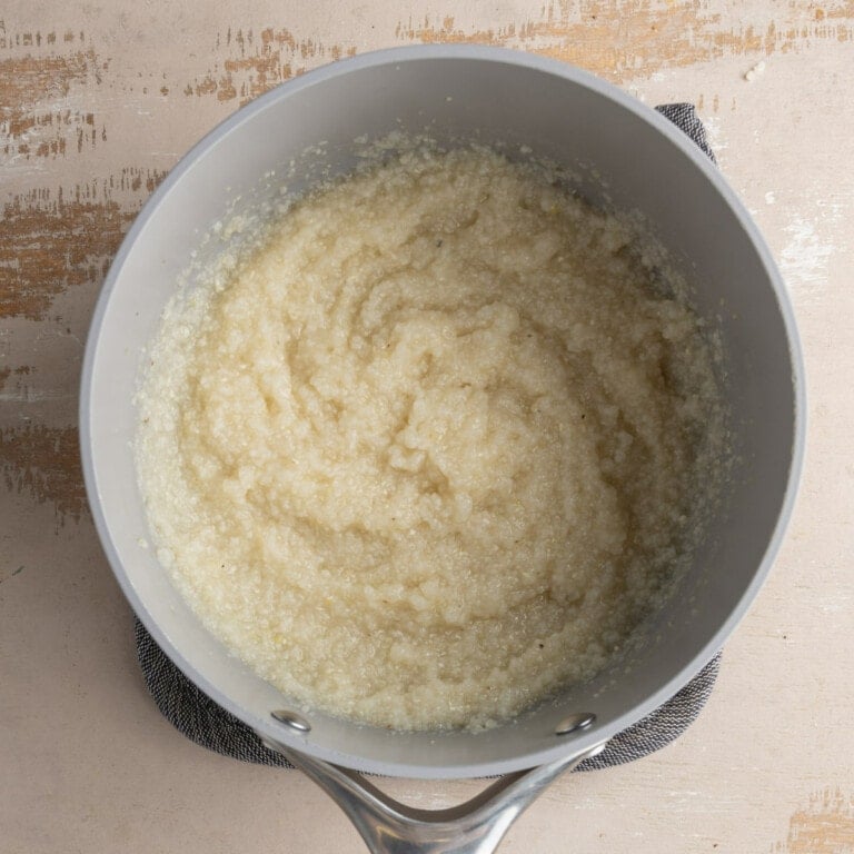 Grits cooked in vegetable broth in a small pot
