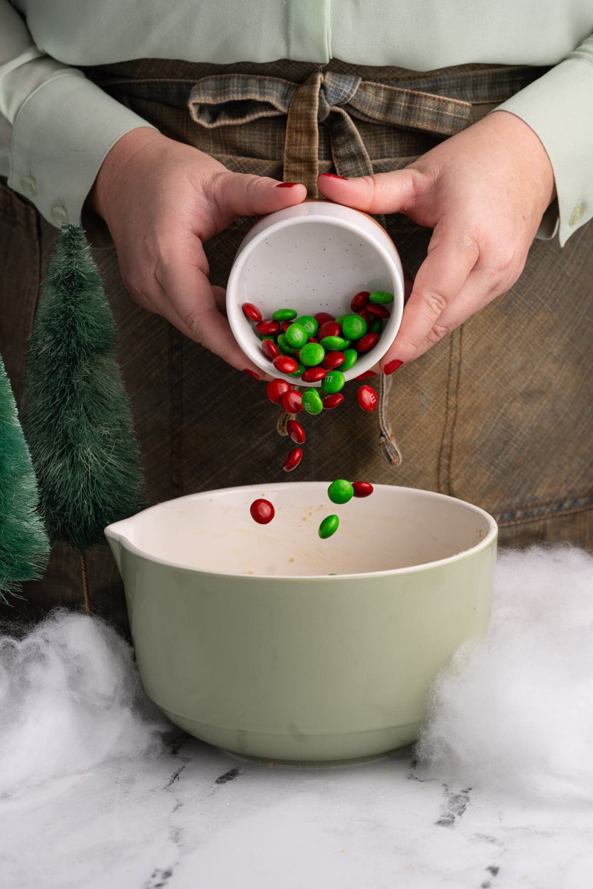 Adding just green and red M&M's to cookie dough to make them festive for Christmas.