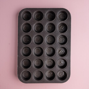 Mini muffin tin sprayed with oil so that brownie bites do not stick.