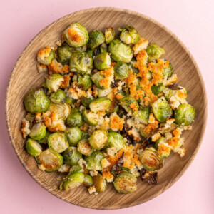 Parmesan Crusted Brussels Sprouts in a shallow wooden bowl.