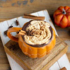 Pumpkin Spice Hot Chocolate garnished with whipped cream, cinnamon stick, and star anise