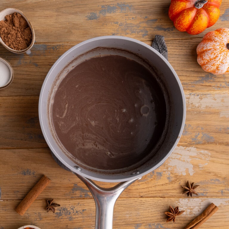 Melted chocolate chips mixed with warm milk in a pot