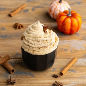 Pumpkin Whipped Cream in a black bowl garnished with star anise