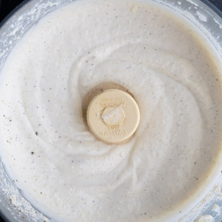 Food processor with whipped ricotta cheese sauce.