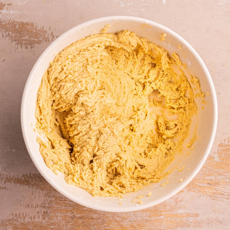 Light brown sugar based cookie dough in a large mixing bowl.