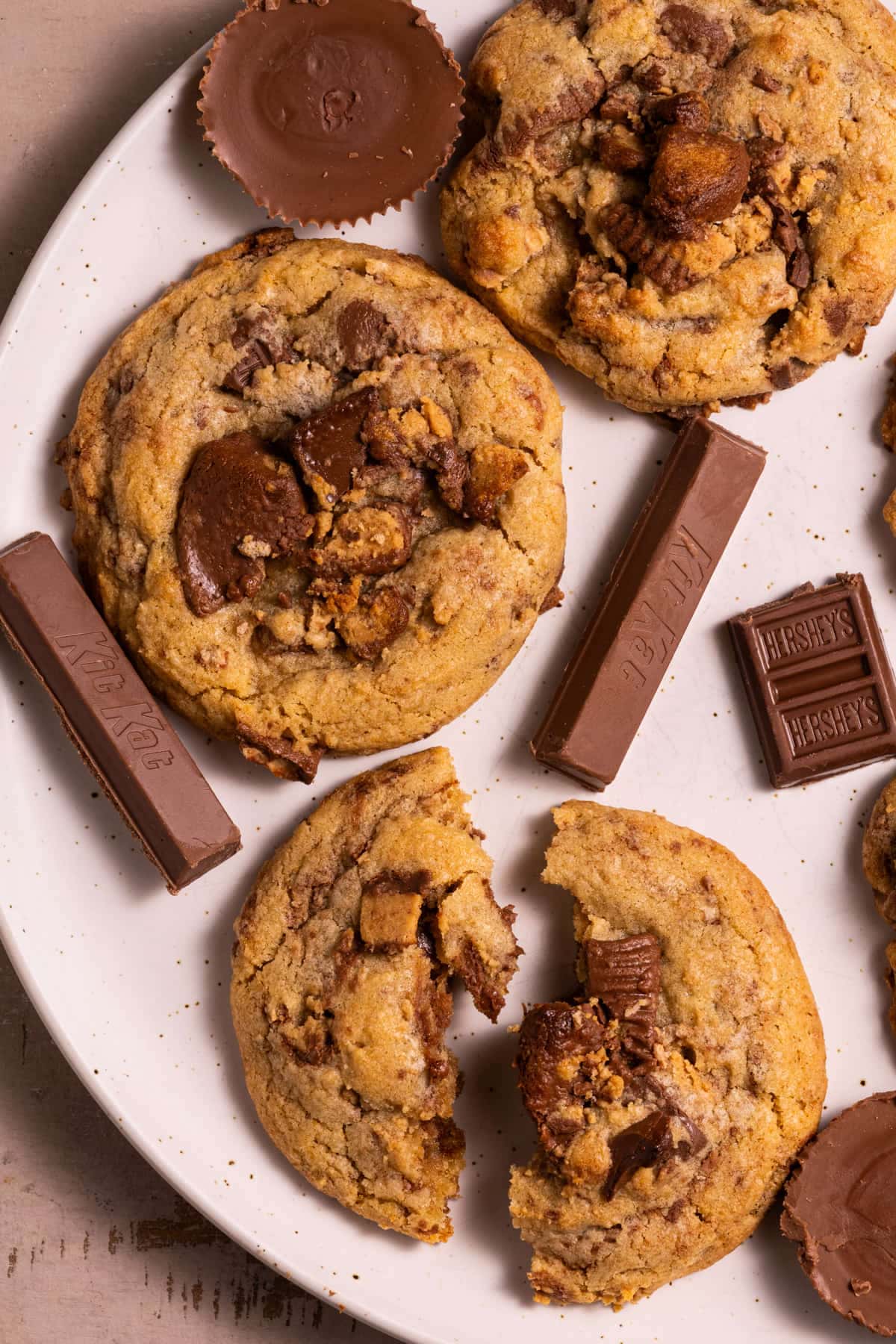 Close up of cookies with leftover Halloween candy, with one cookie broken in half.  