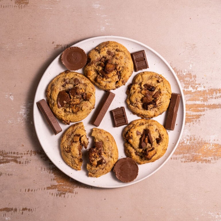 White plate with cookies with leftover Halloween candy.