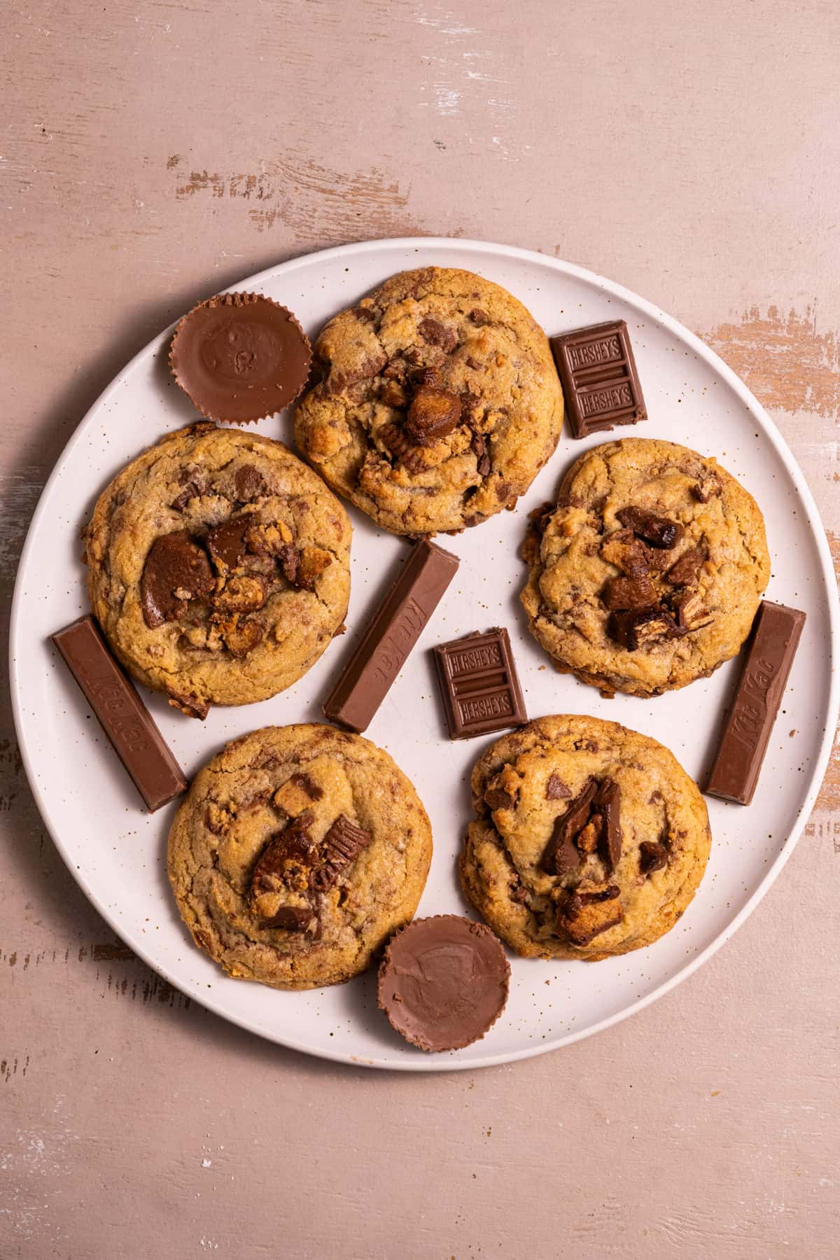 White plate with Leftover Halloween Candy cookies and a variety of chocolate candies.