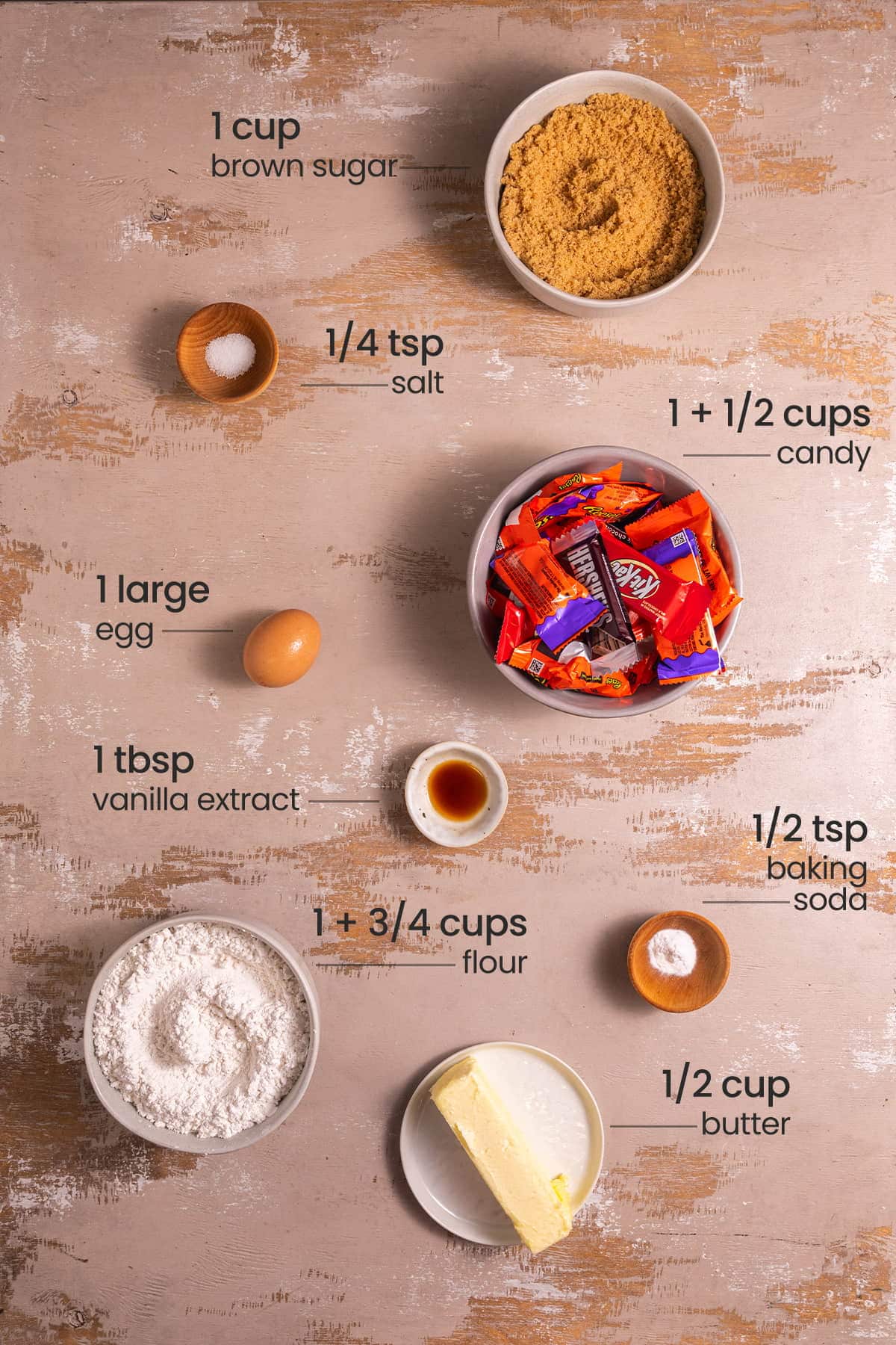 ingredients for leftover halloween candy cookies - brown sugar, salt, candy, egg, vanilla extract, baking soda, flour, butter