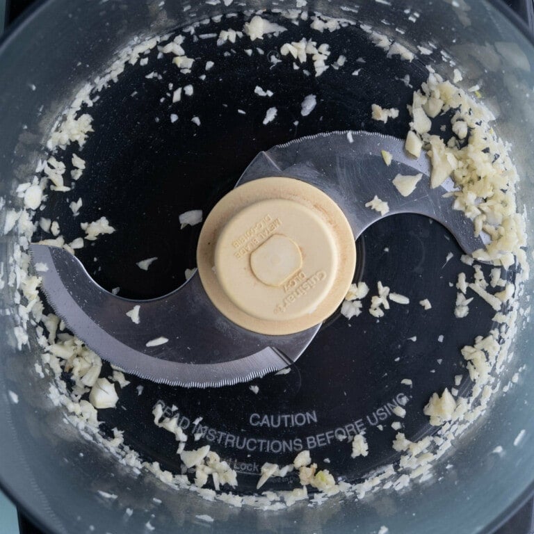 Garlic in the food processor and blended until minced.