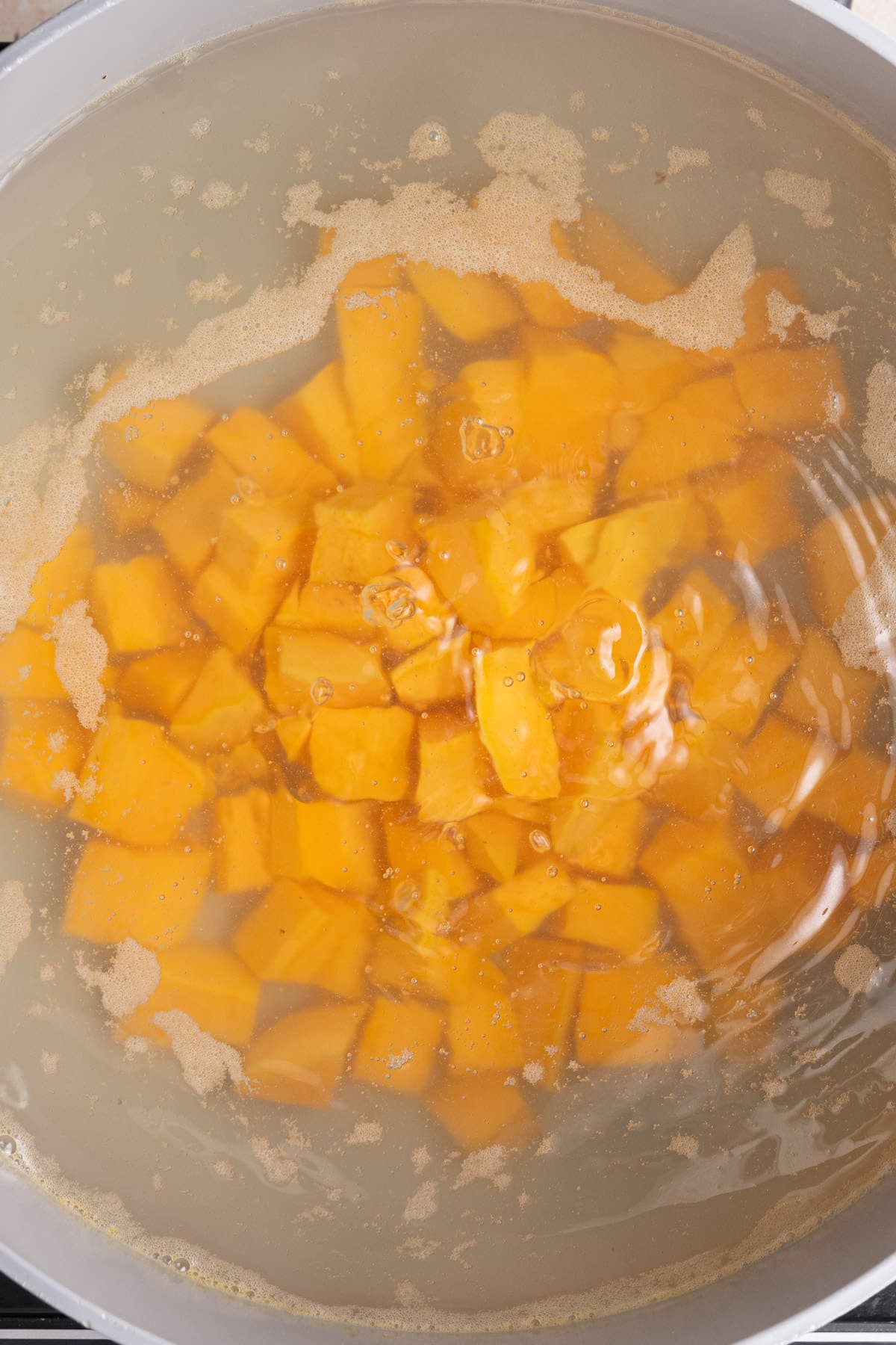 Boiling sweet potato to get it tender to make pie filling.