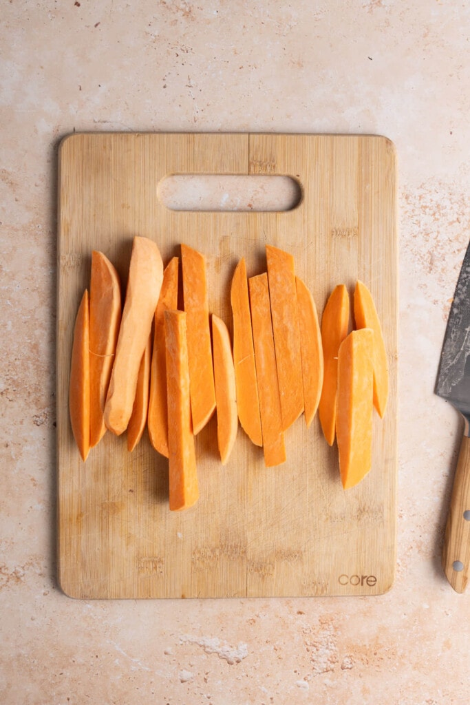 Cutting sweet potato into strips.