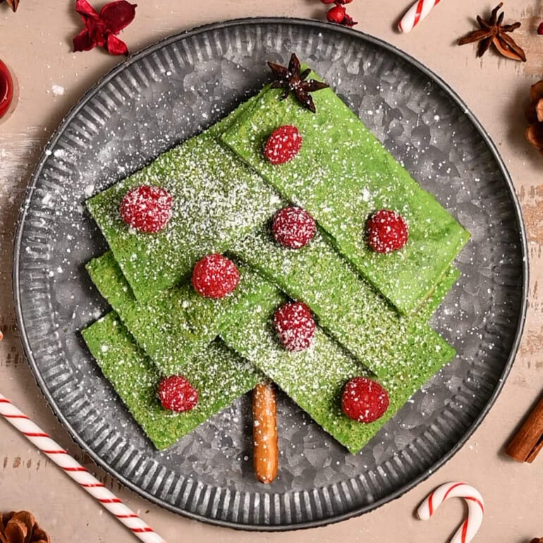 Christmas pancakes cut into rectangles and shaped on a plate like a Christmas tree.