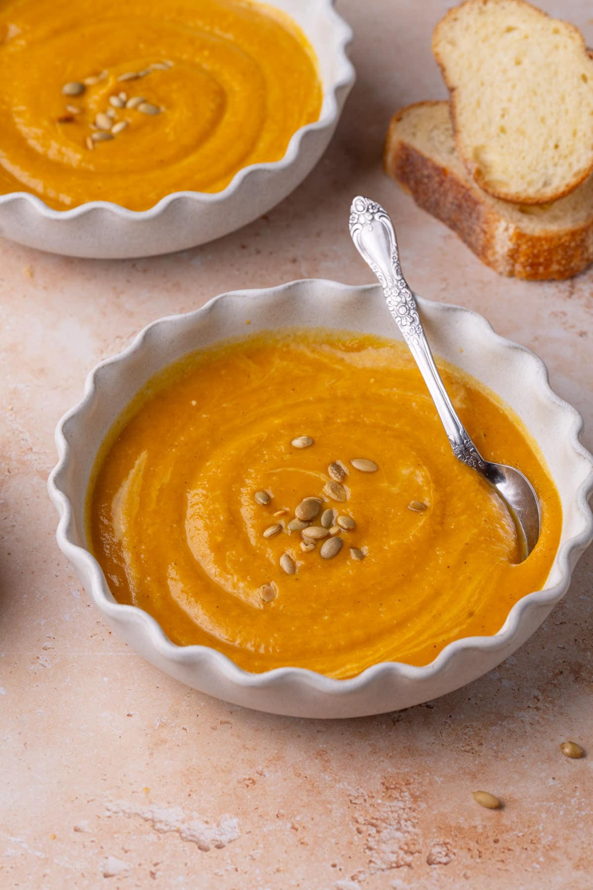 Close up of thick and creamy Autumn Squash Soup with a spoon. 