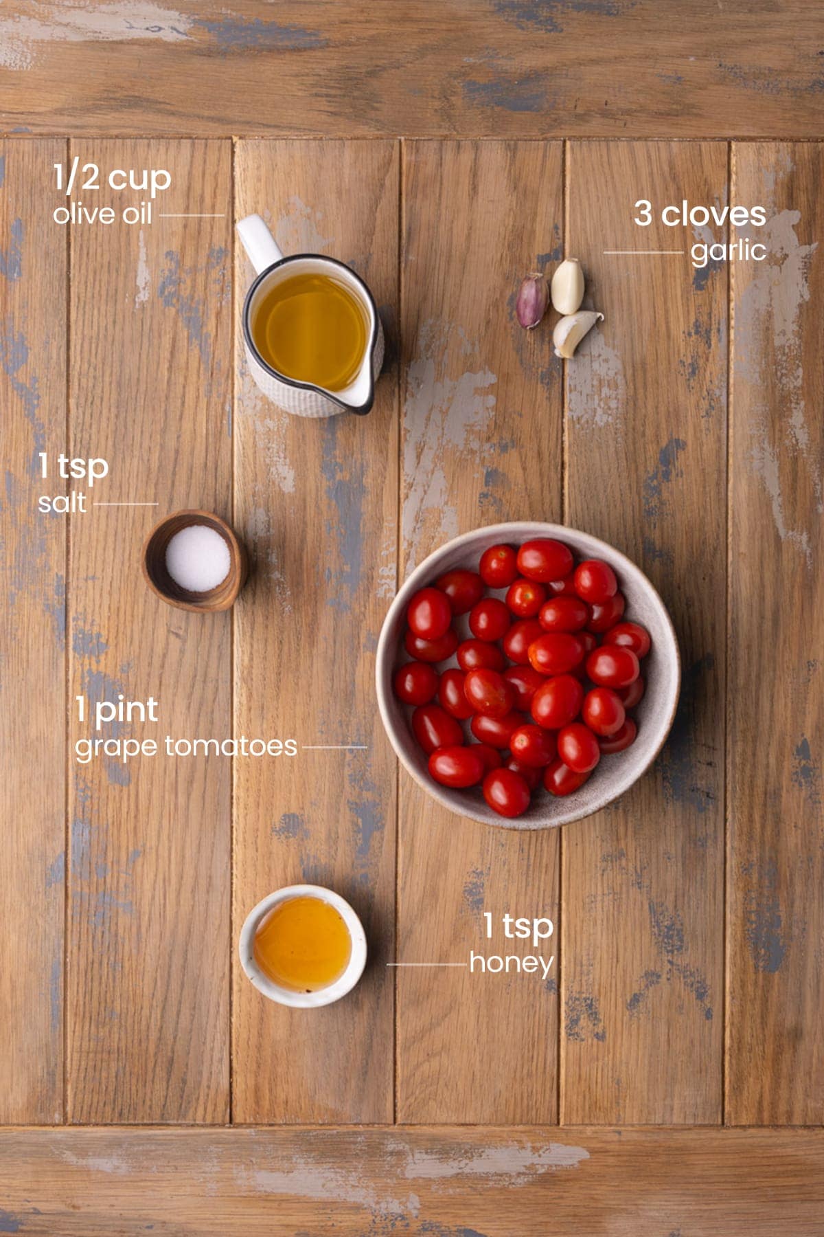 Ingredients for grape tomato confit - tomatoes, garlic, olive oil, salt, honey