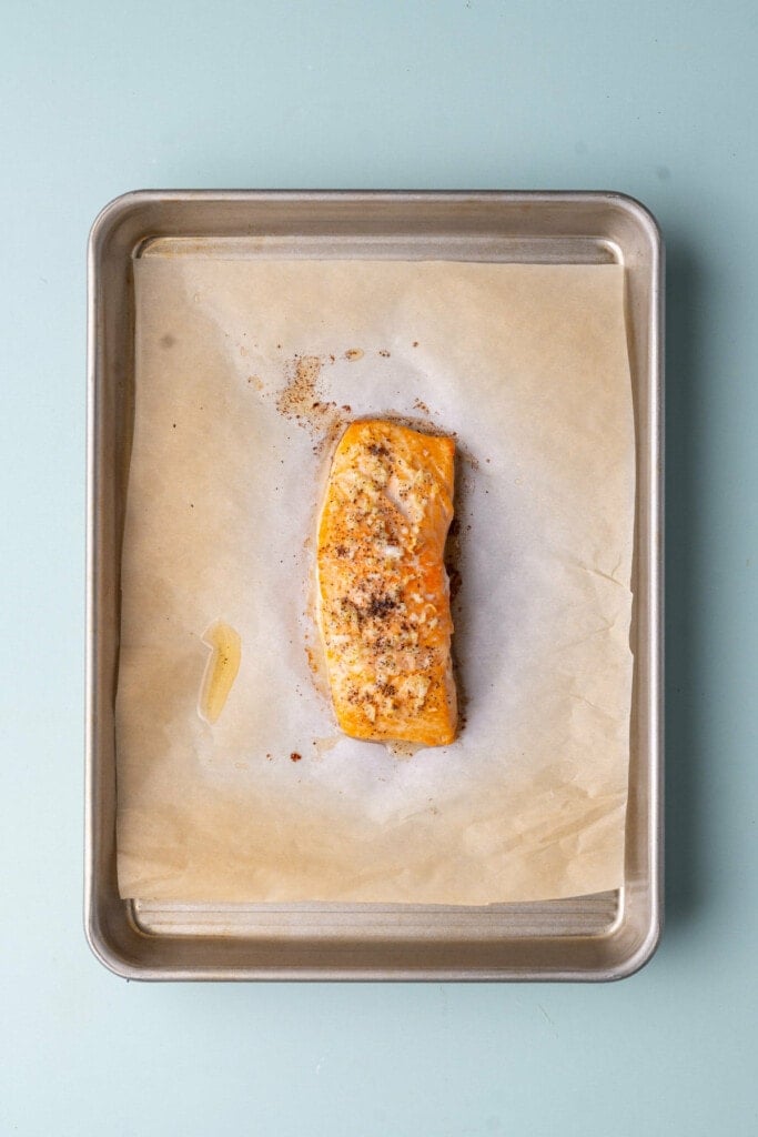 Roasted garlic salmon on a piece of parchment paper. 