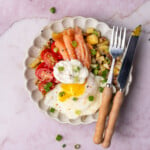 Smoked salmon breakfast bowl with tomatoes and a fried egg.