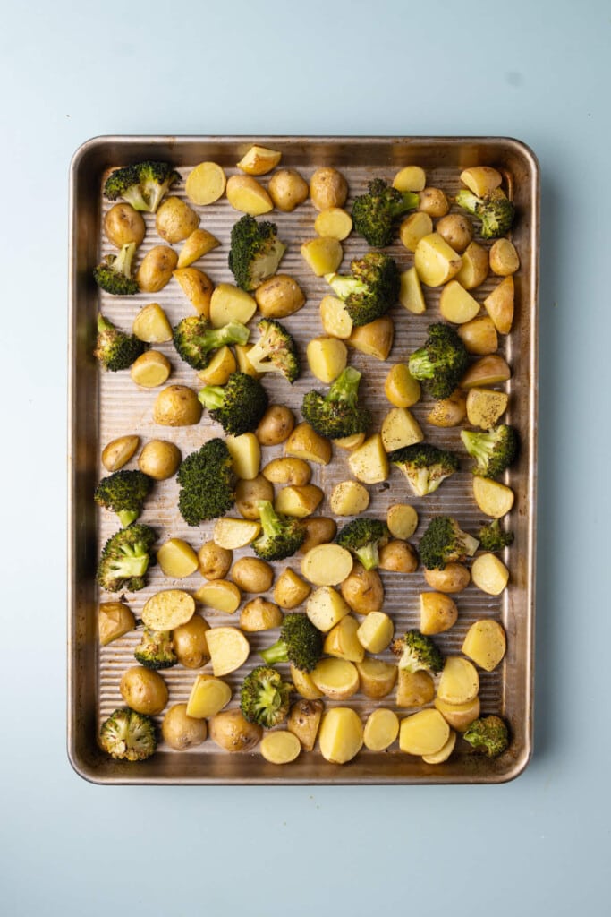 Roasted broccoli and potatoes fresh out of the oven, just roasted on a sheet pan.
