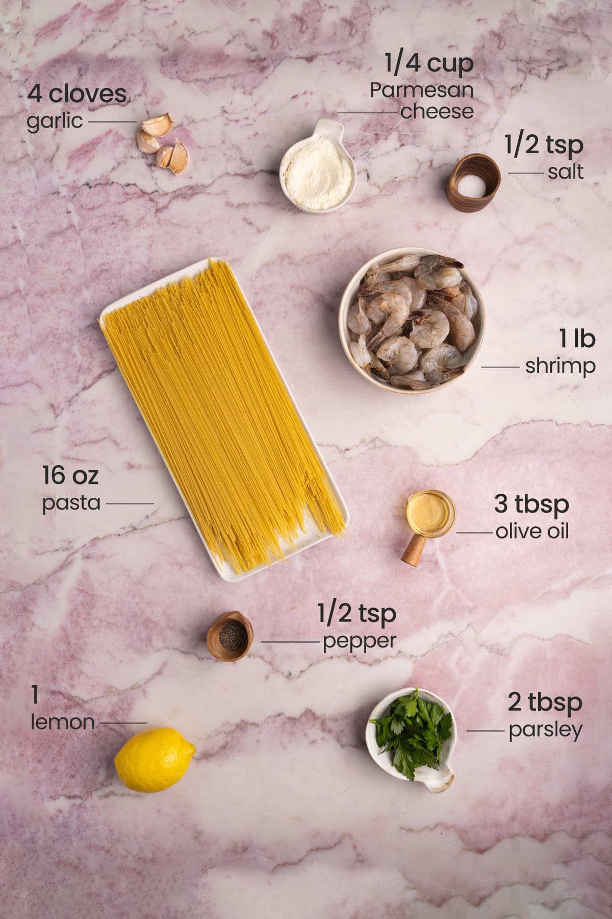 ingredients for lemon shrimp pasta - parmesan cheese, garlic, salt, shrimp, pasta, olive oil, pepper, lemon, parsley