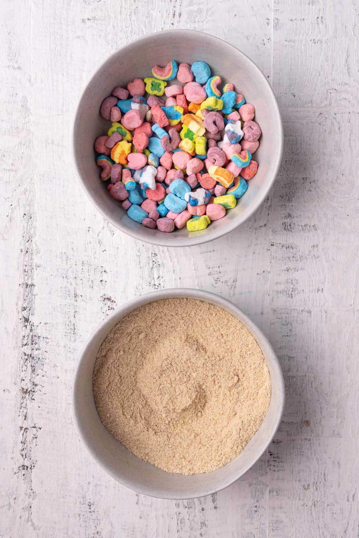 Bowl of Lucky Charms marshmallows only, and second bowl of ground up cereal.