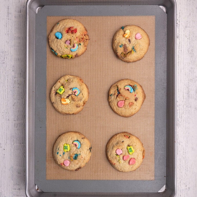 Lucky Charms cookies fresh out of the oven with marshmallows pushed into the top.