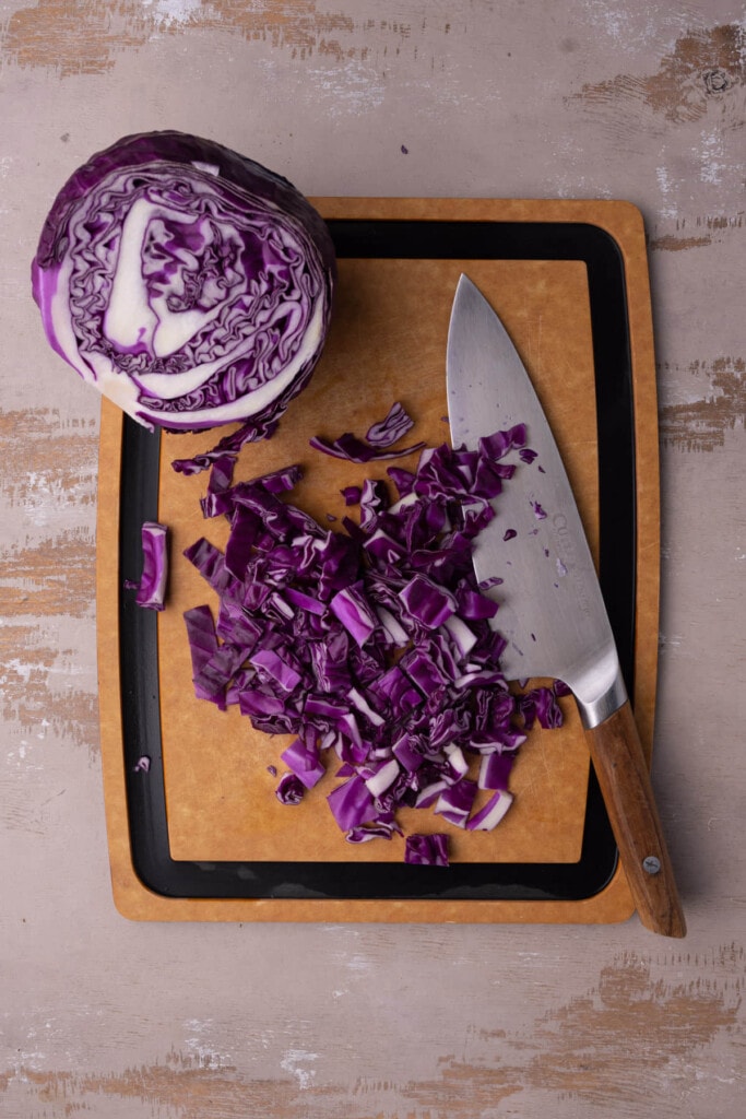 Chopping red cabbage to make a Baja slaw for fish tacos.
