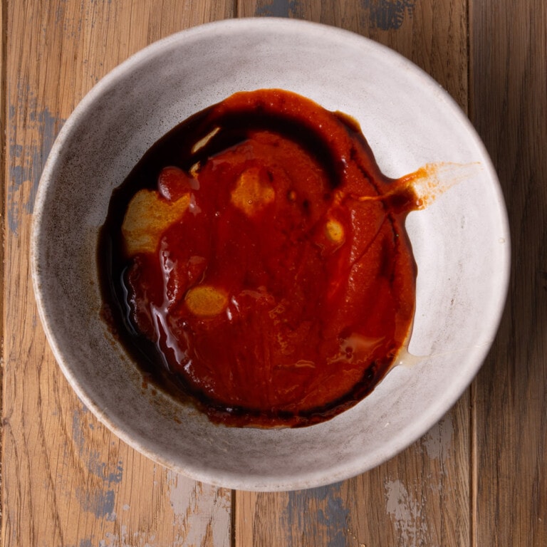 Sriracha, honey, and soy sauce in a small bowl to make an easy and flavorful salmon marinade.