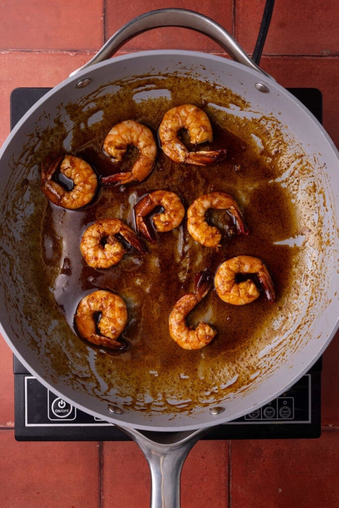 Cooking shrimp in a pan with tequila lime marinade. 
