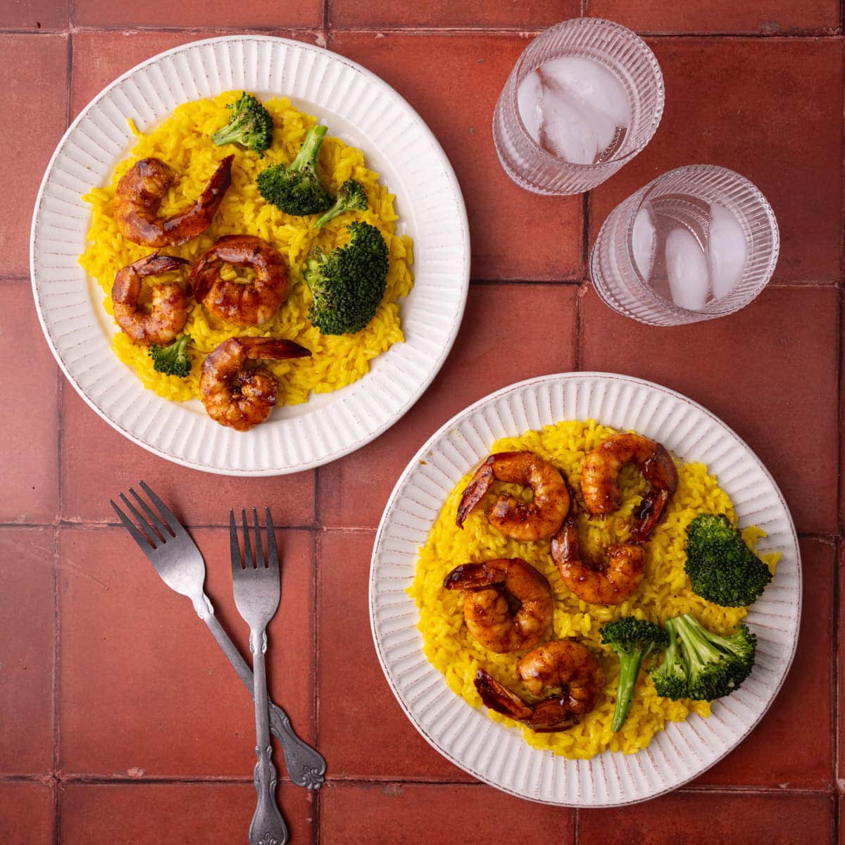 Tequila lime shrimp served with yellow rice and broccoli.