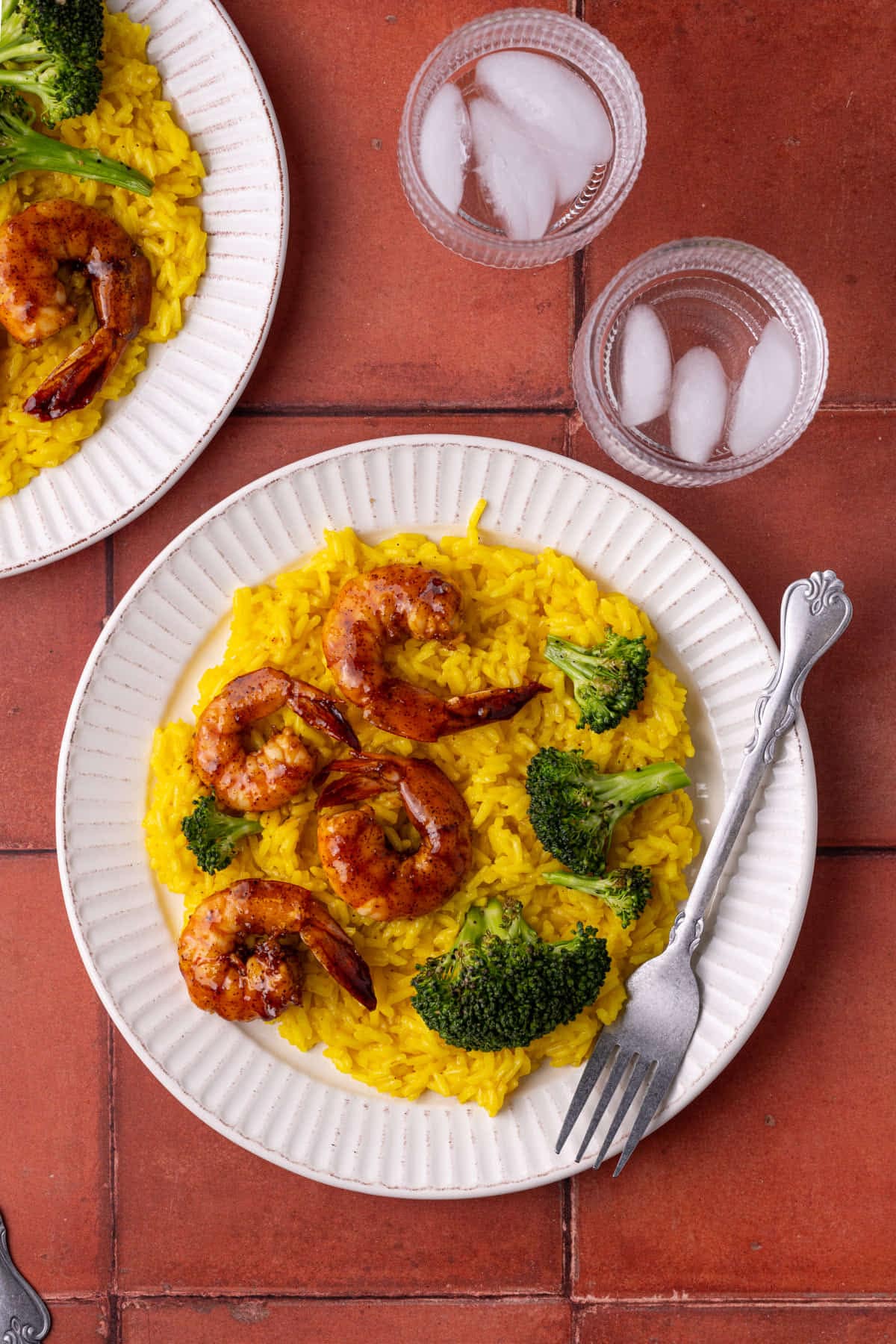 Overhead image of plate with rice, broccoli, and shrimp. 