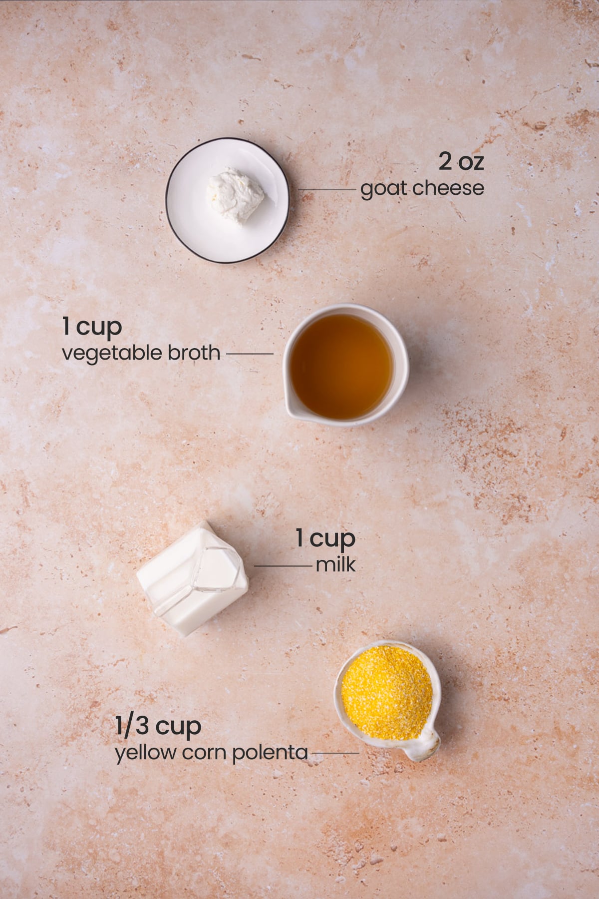Overhead image of ingredients for polenta with goat cheese - goat cheese, vegetable broth, milk, and yellow corn polenta.