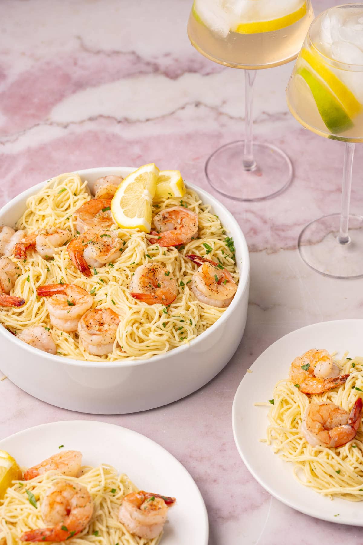 Shrimp Lemon Pasta in a serving bowl with a small serving on a plate. 