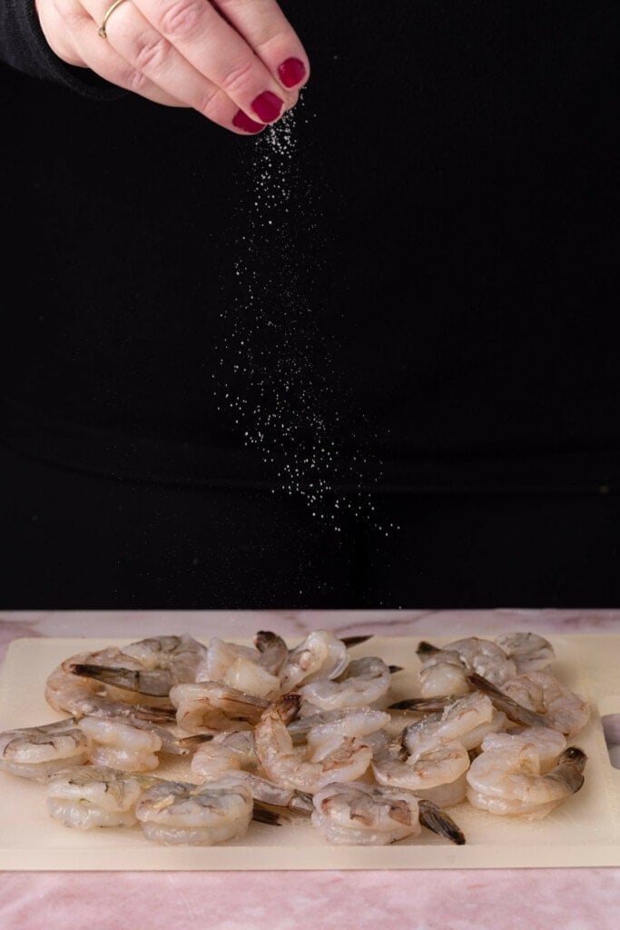 Seasoning raw shrimp with salt and pepper. 