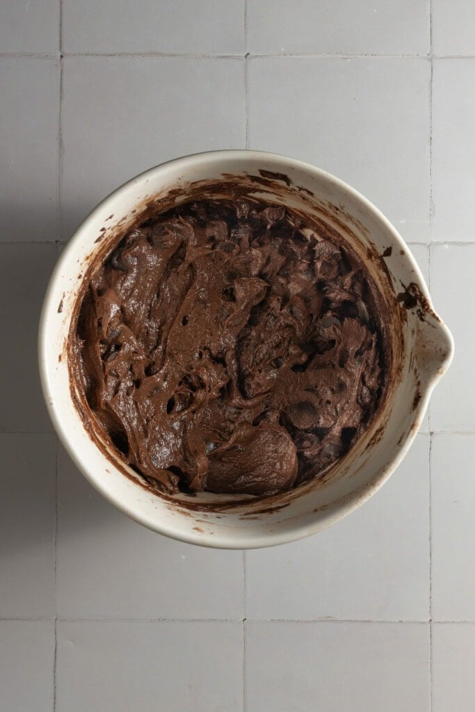 Chocolate chip brownie batter ready to transfer to prepped pan.