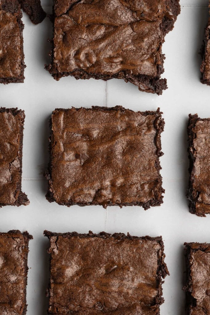 Chocolate chip brownies lined up with a little space in between each one.